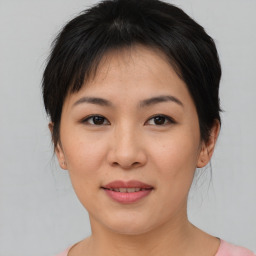 Joyful asian young-adult female with medium  brown hair and brown eyes