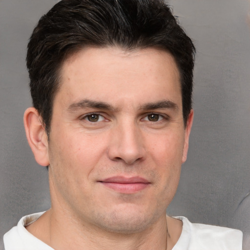 Joyful white adult male with short  brown hair and brown eyes