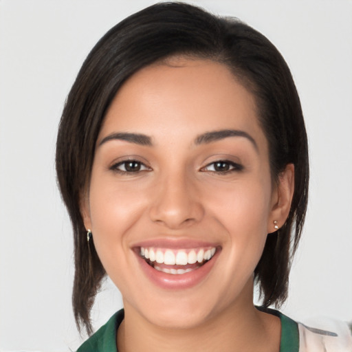 Joyful latino young-adult female with medium  brown hair and brown eyes