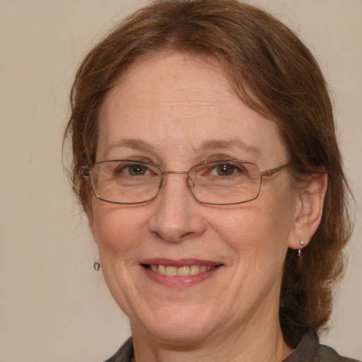 Joyful white middle-aged female with medium  brown hair and blue eyes