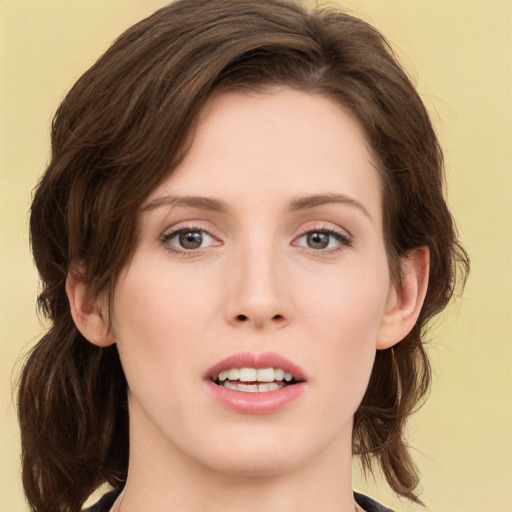 Joyful white young-adult female with medium  brown hair and green eyes