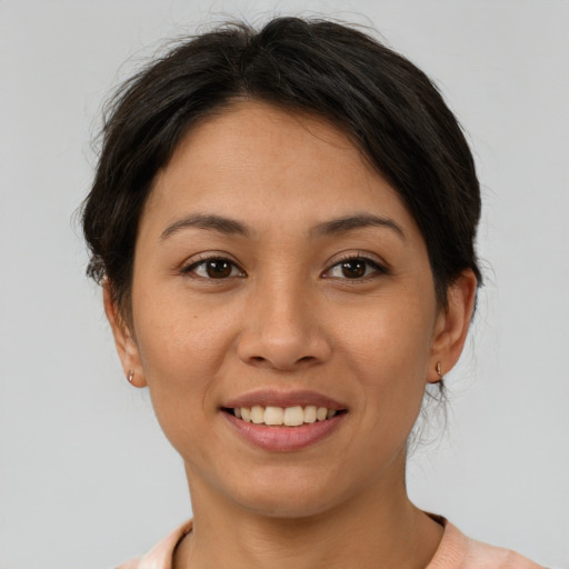 Joyful asian young-adult female with short  brown hair and brown eyes