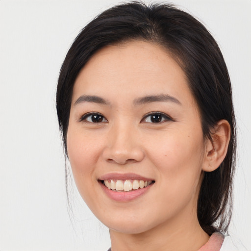 Joyful white young-adult female with medium  brown hair and brown eyes