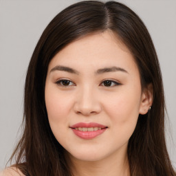 Joyful asian young-adult female with long  brown hair and brown eyes