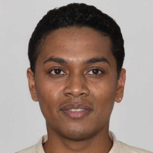 Joyful black young-adult male with short  black hair and brown eyes
