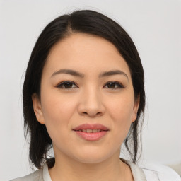 Joyful asian young-adult female with medium  brown hair and brown eyes