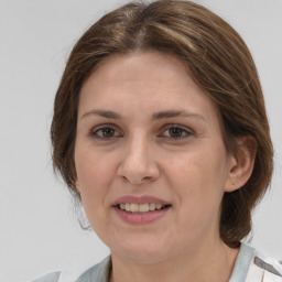 Joyful white adult female with medium  brown hair and grey eyes