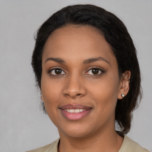 Joyful black young-adult female with medium  black hair and brown eyes