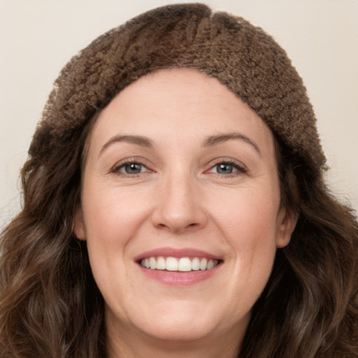 Joyful white young-adult female with long  brown hair and green eyes