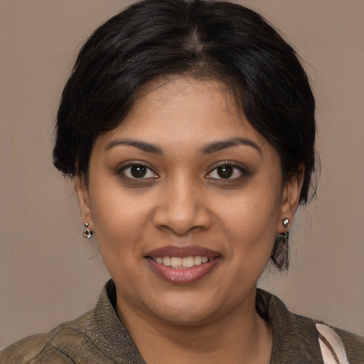 Joyful black young-adult female with medium  brown hair and brown eyes