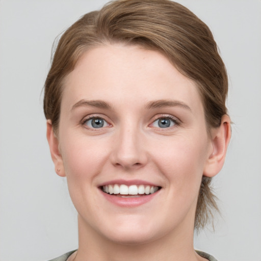 Joyful white young-adult female with medium  brown hair and blue eyes