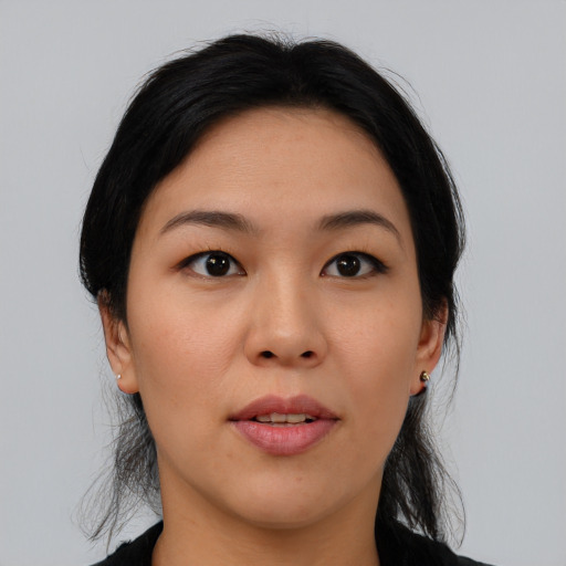 Joyful asian young-adult female with medium  black hair and brown eyes