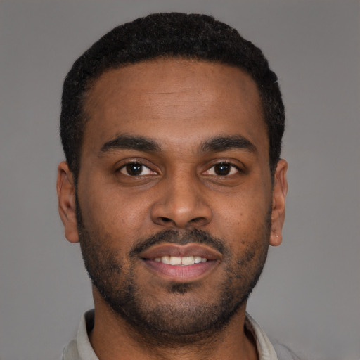 Joyful latino young-adult male with short  brown hair and brown eyes