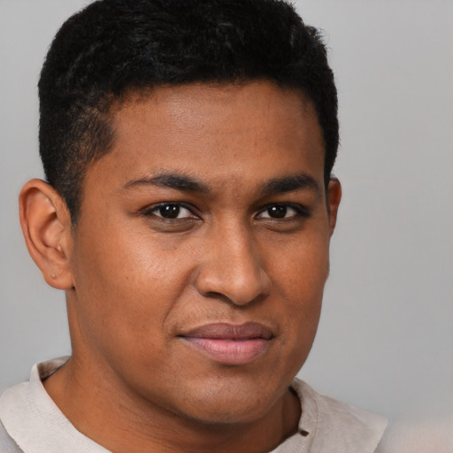 Joyful black young-adult male with short  brown hair and brown eyes