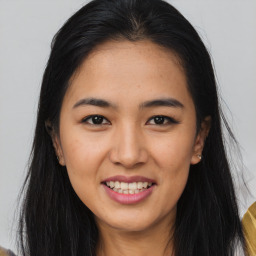 Joyful asian young-adult female with long  brown hair and brown eyes