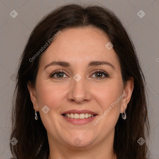 Joyful white adult female with long  brown hair and brown eyes