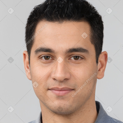 Joyful white young-adult male with short  black hair and brown eyes