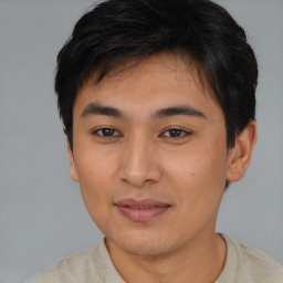 Joyful asian young-adult male with short  brown hair and brown eyes