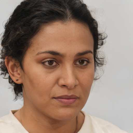 Neutral latino adult female with medium  brown hair and brown eyes