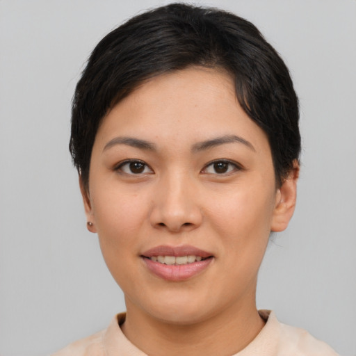 Joyful asian young-adult female with short  brown hair and brown eyes