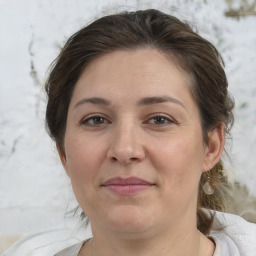 Joyful white adult female with medium  brown hair and brown eyes