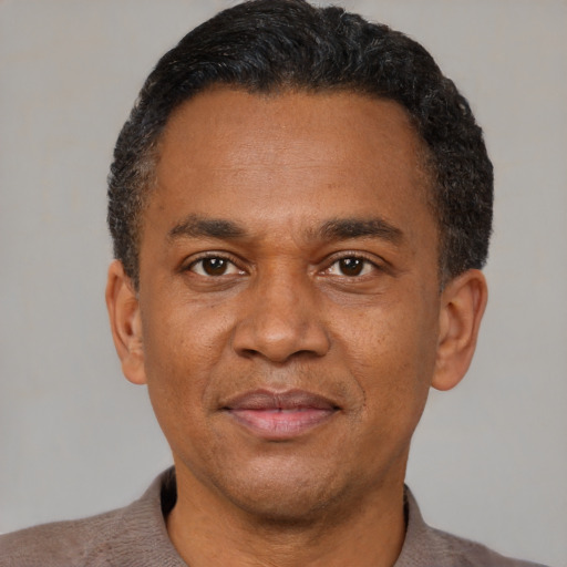 Joyful latino adult male with short  black hair and brown eyes