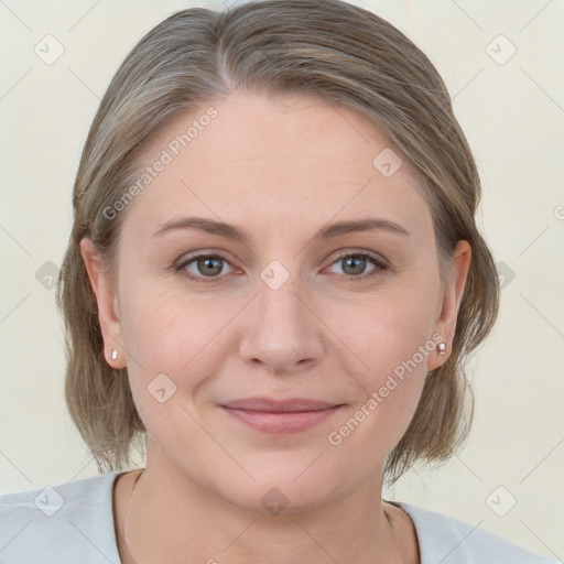 Joyful white young-adult female with medium  brown hair and grey eyes