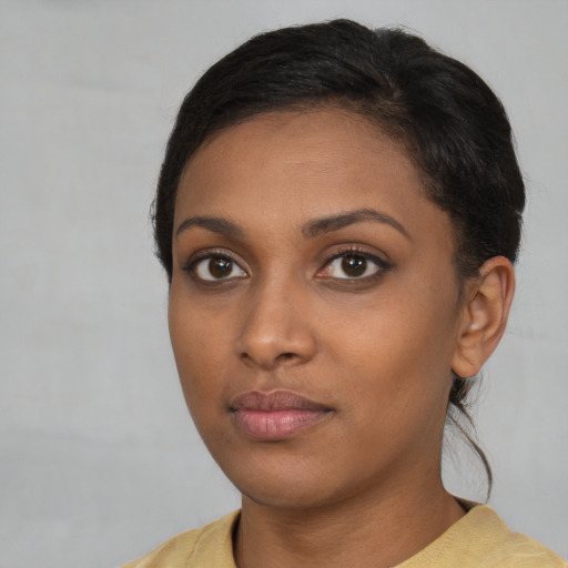 Neutral black young-adult female with short  brown hair and brown eyes