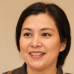 Joyful white adult female with medium  brown hair and brown eyes