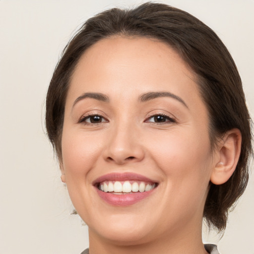 Joyful white young-adult female with medium  brown hair and brown eyes