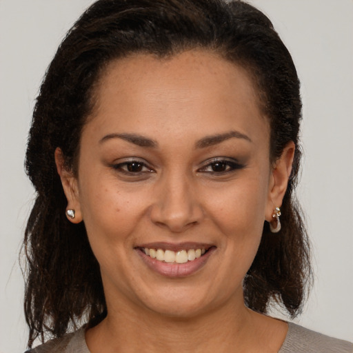 Joyful black young-adult female with medium  brown hair and brown eyes