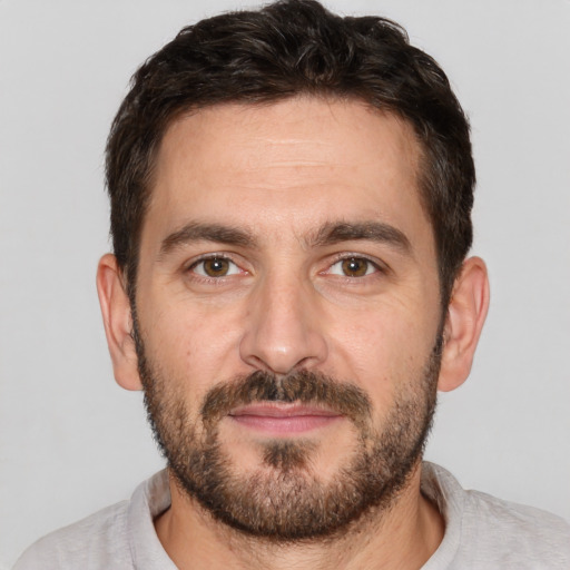 Joyful white adult male with short  brown hair and brown eyes