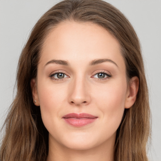 Joyful white young-adult female with long  brown hair and grey eyes