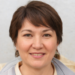 Joyful white adult female with medium  brown hair and brown eyes