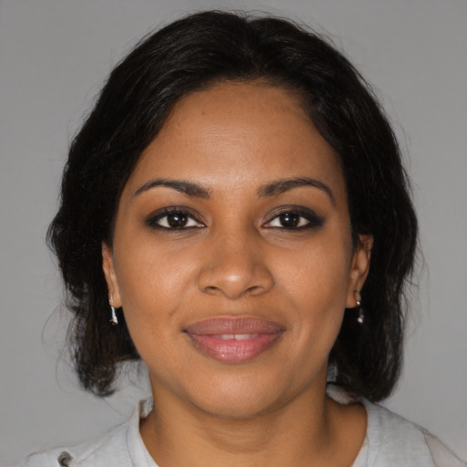 Joyful black young-adult female with medium  brown hair and brown eyes