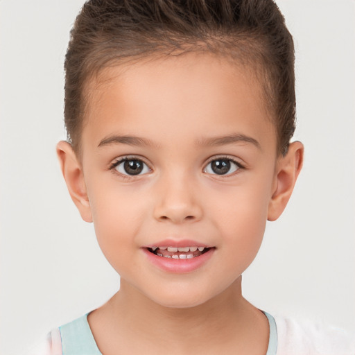 Joyful white child female with short  brown hair and brown eyes