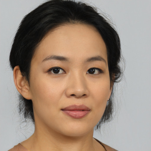 Joyful asian young-adult female with medium  brown hair and brown eyes