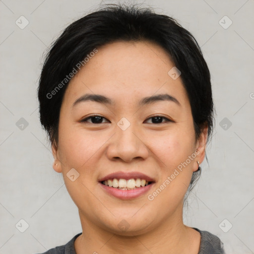 Joyful asian young-adult female with short  black hair and brown eyes