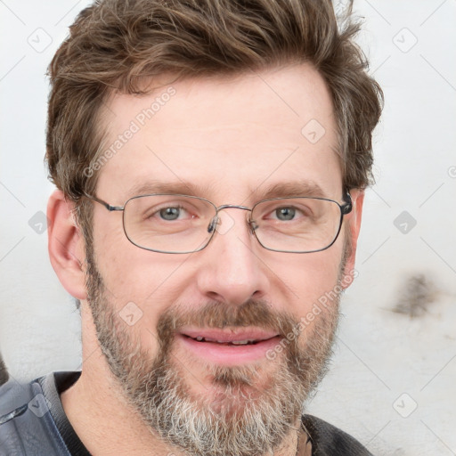 Joyful white adult male with short  brown hair and grey eyes