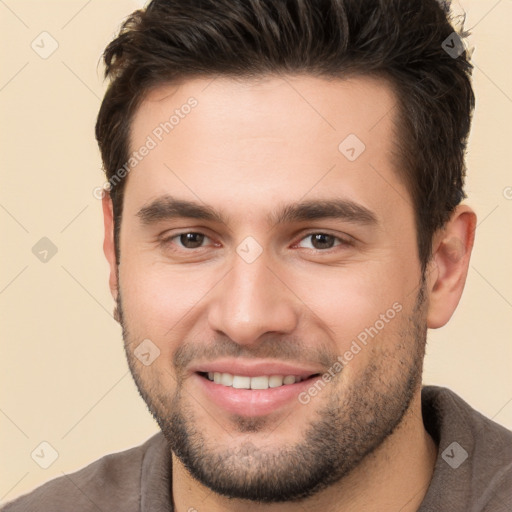 Joyful white young-adult male with short  brown hair and brown eyes