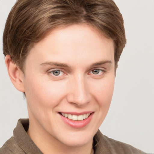 Joyful white young-adult female with short  brown hair and grey eyes