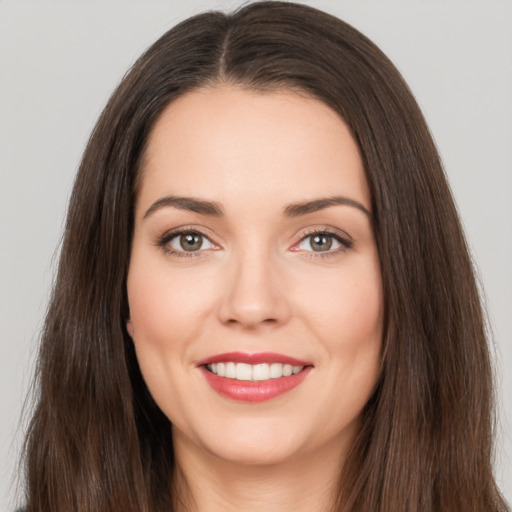 Joyful white young-adult female with long  brown hair and brown eyes