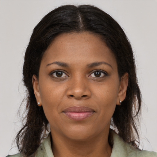Joyful black young-adult female with medium  brown hair and brown eyes