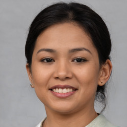 Joyful asian young-adult female with medium  brown hair and brown eyes