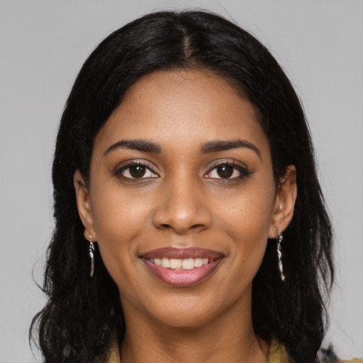 Joyful black young-adult female with long  black hair and brown eyes