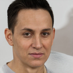 Joyful white adult male with short  brown hair and brown eyes