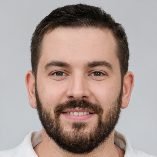 Joyful white young-adult male with short  brown hair and brown eyes