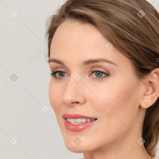 Joyful white young-adult female with long  brown hair and blue eyes