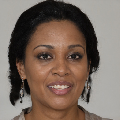 Joyful black adult female with medium  brown hair and brown eyes