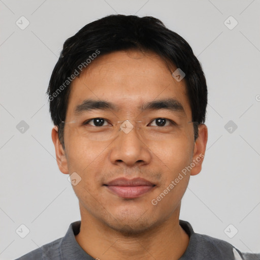 Joyful asian young-adult male with short  black hair and brown eyes